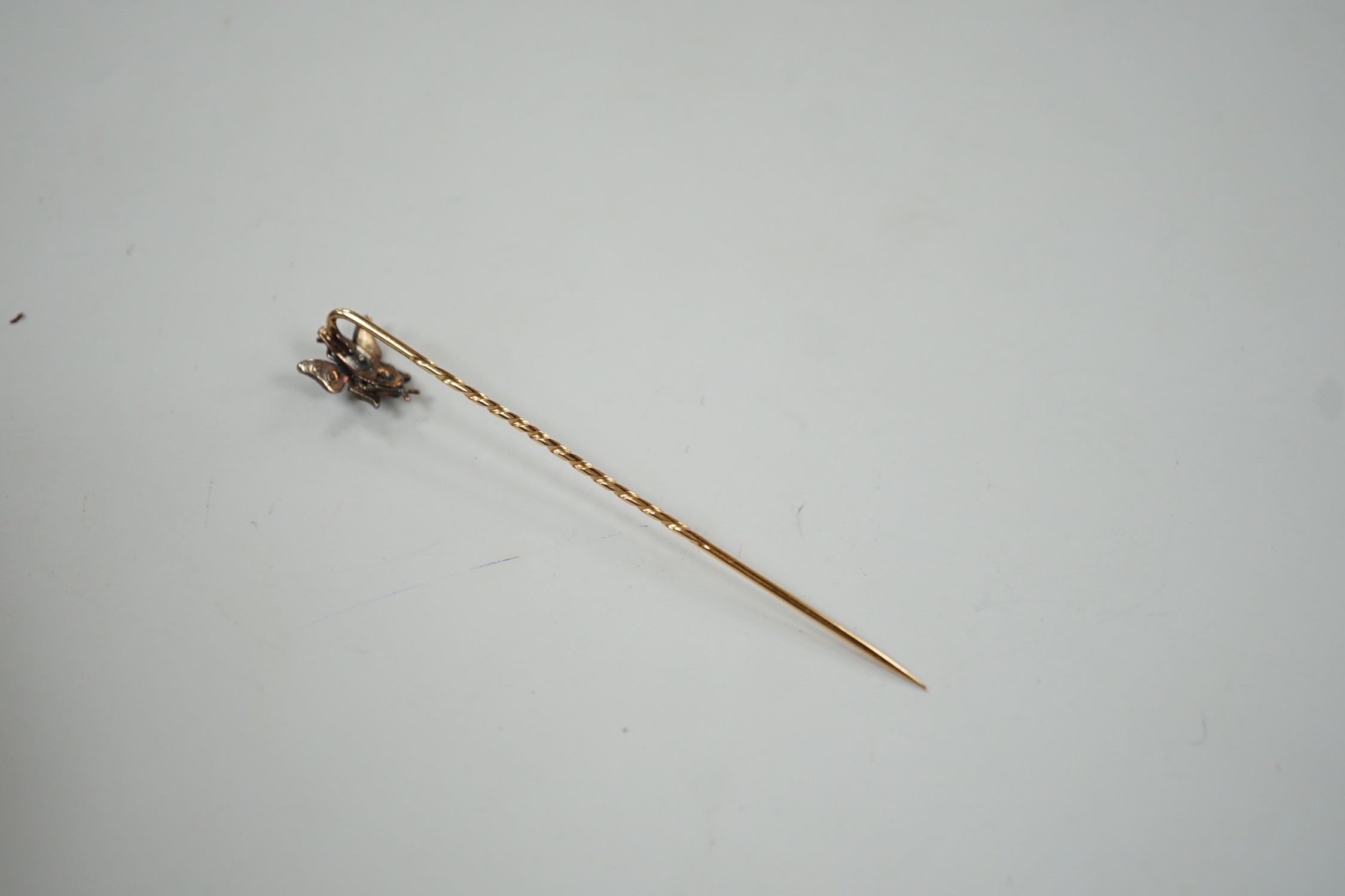 A Victorian yellow metal, pink stone and rose cut diamond set bug stick pin, 72mm, gross weight 1.6 grams.